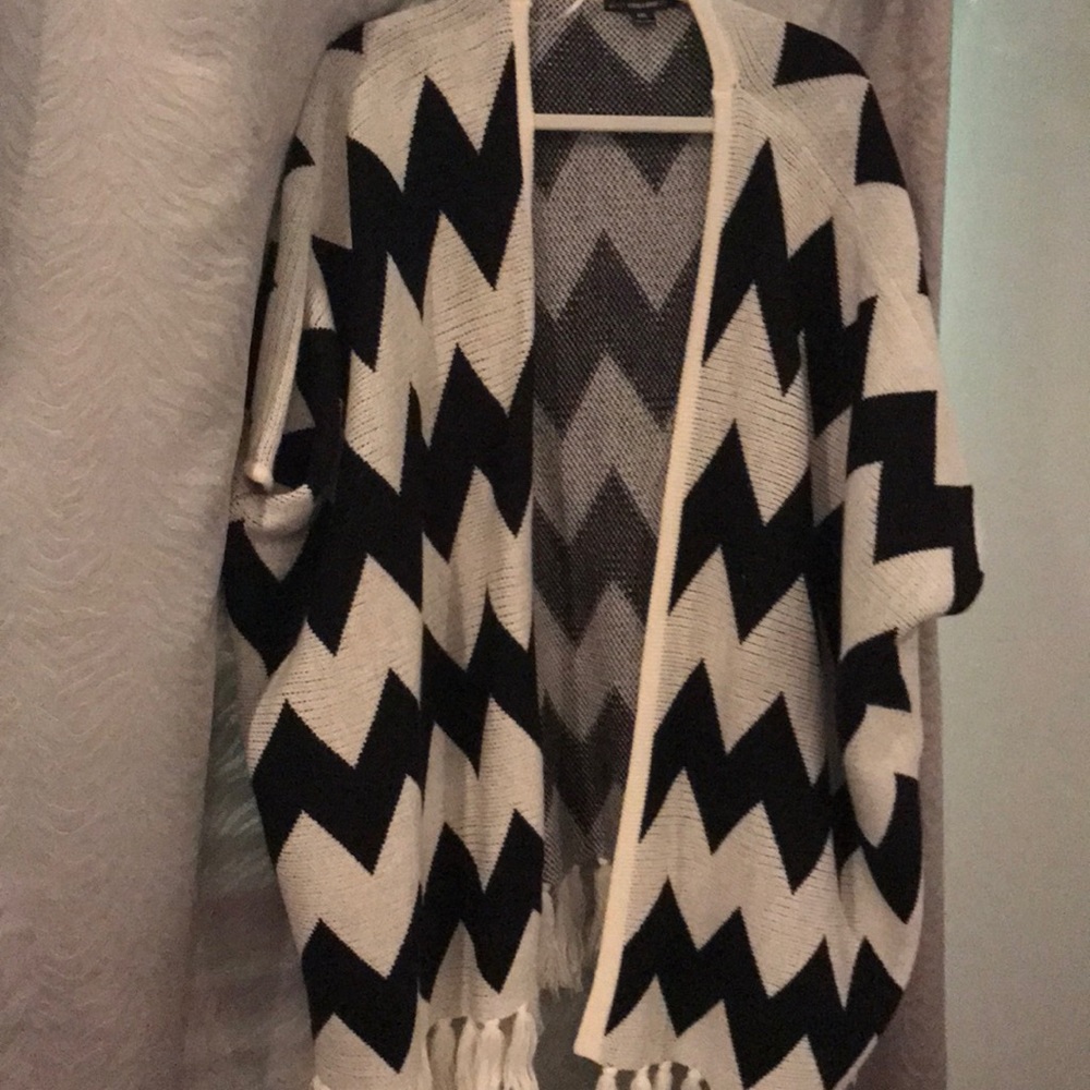 White and black chevron poncho with fringe detail